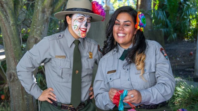 Two park rangers prepare for Dia de los Muertos celebrations