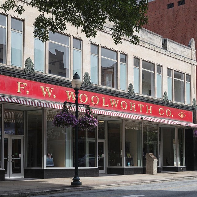 exterior of building with sign F. W. Woolworth Co. above storefront