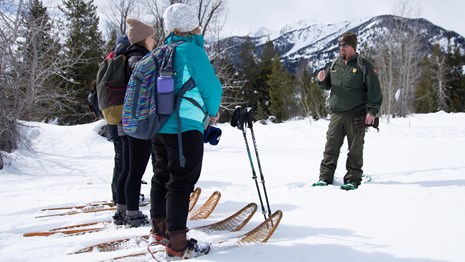 Ranger and visitors on a snowshoe hike.