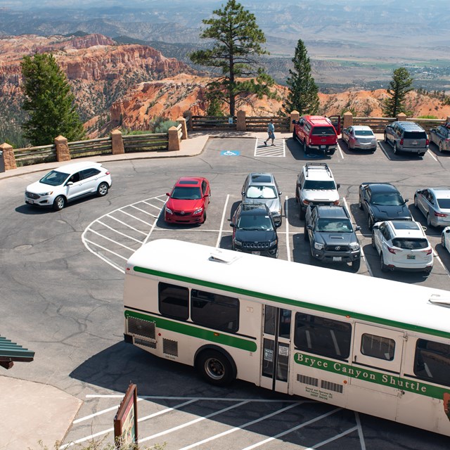 An overhead photo of a parking lot with a shuttle bus in the foreground.