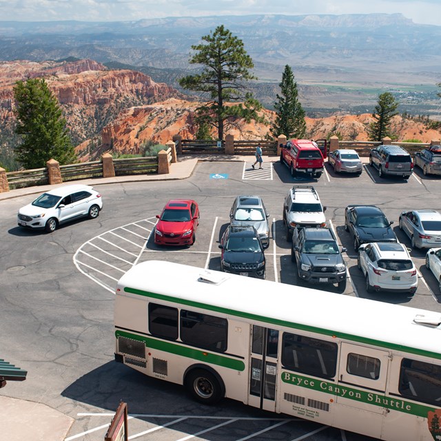 An overhead photo of a parking lot with a shuttle bus in the foreground.