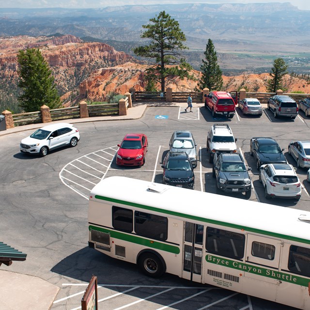 An overhead photo of a parking lot with a shuttle bus in the foreground.