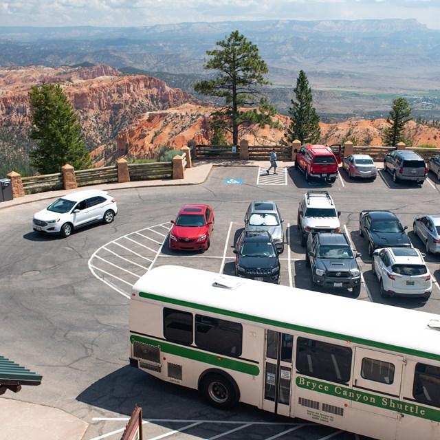 An overhead photo of a parking lot with a shuttle bus in the foreground.