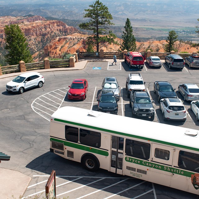 An overhead photo of a parking lot with a shuttle bus in the foreground.