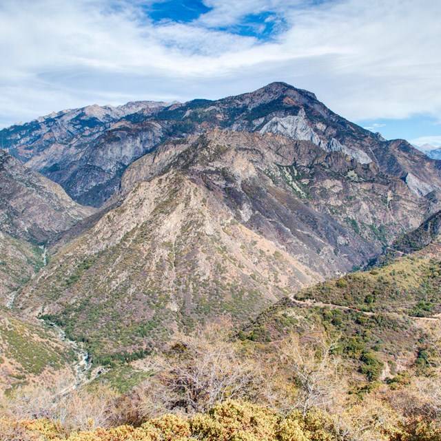 A large valley with two rivers converging into each other. 
