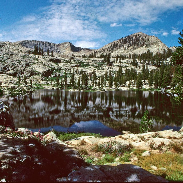 A large lake surrounded by forested granite walls.