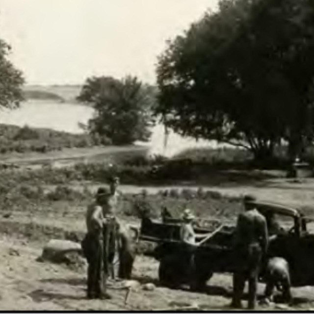 Black and white image of workers on the island.