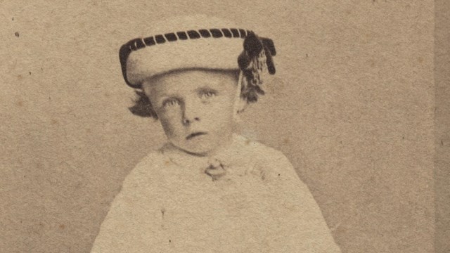 Young Theodore Roosevelt in his christening gown.