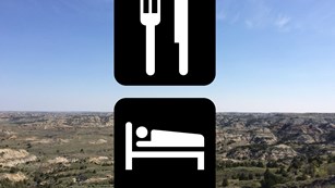 international symbols for lodging and dining in front of a badlands scenic backdrop