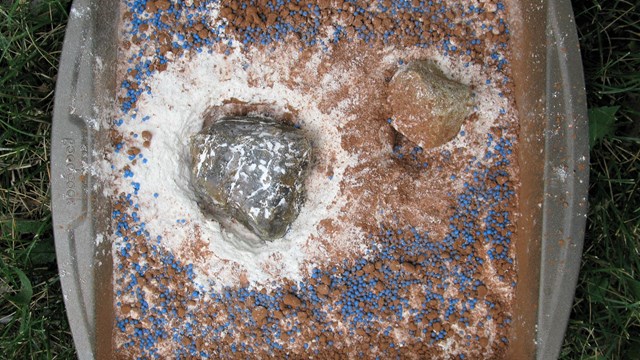 Asteroid Impact Model with flour, sprinkles, cocoa, and rocks