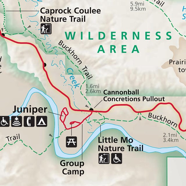 A closeup of a section of the park's map shows a campground, roads, trails, and a river. 