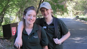 Two youth volunteers pose on the hiking trail.