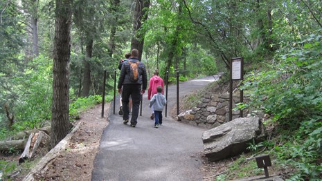 People hiking up a paved path