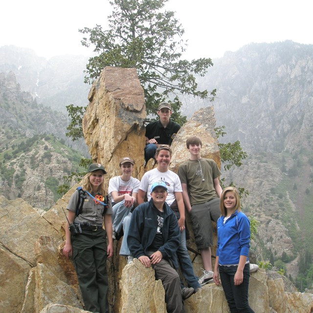 Youth volunteers with shovels smiling for camera