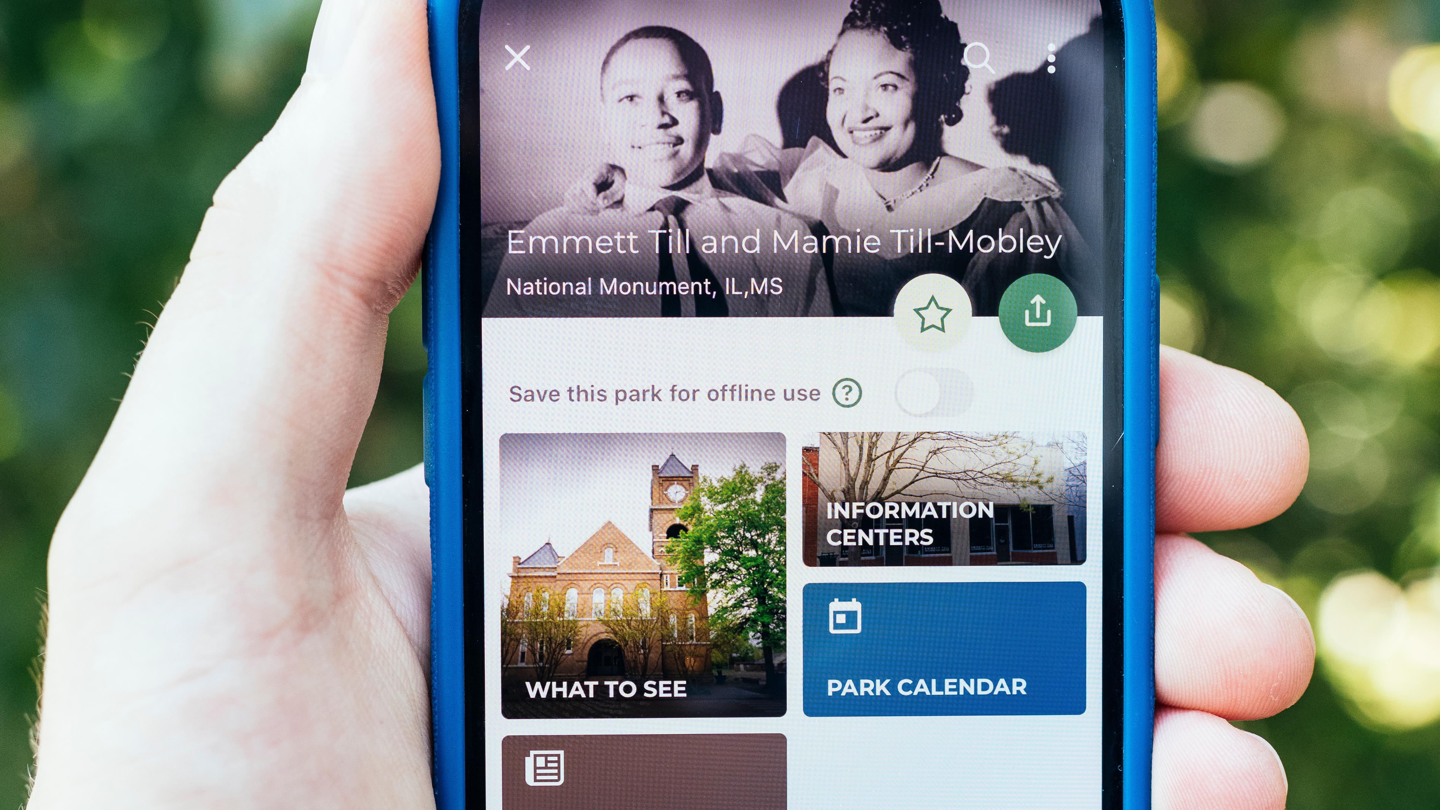 Handed holding a mobile phone with the NPS App