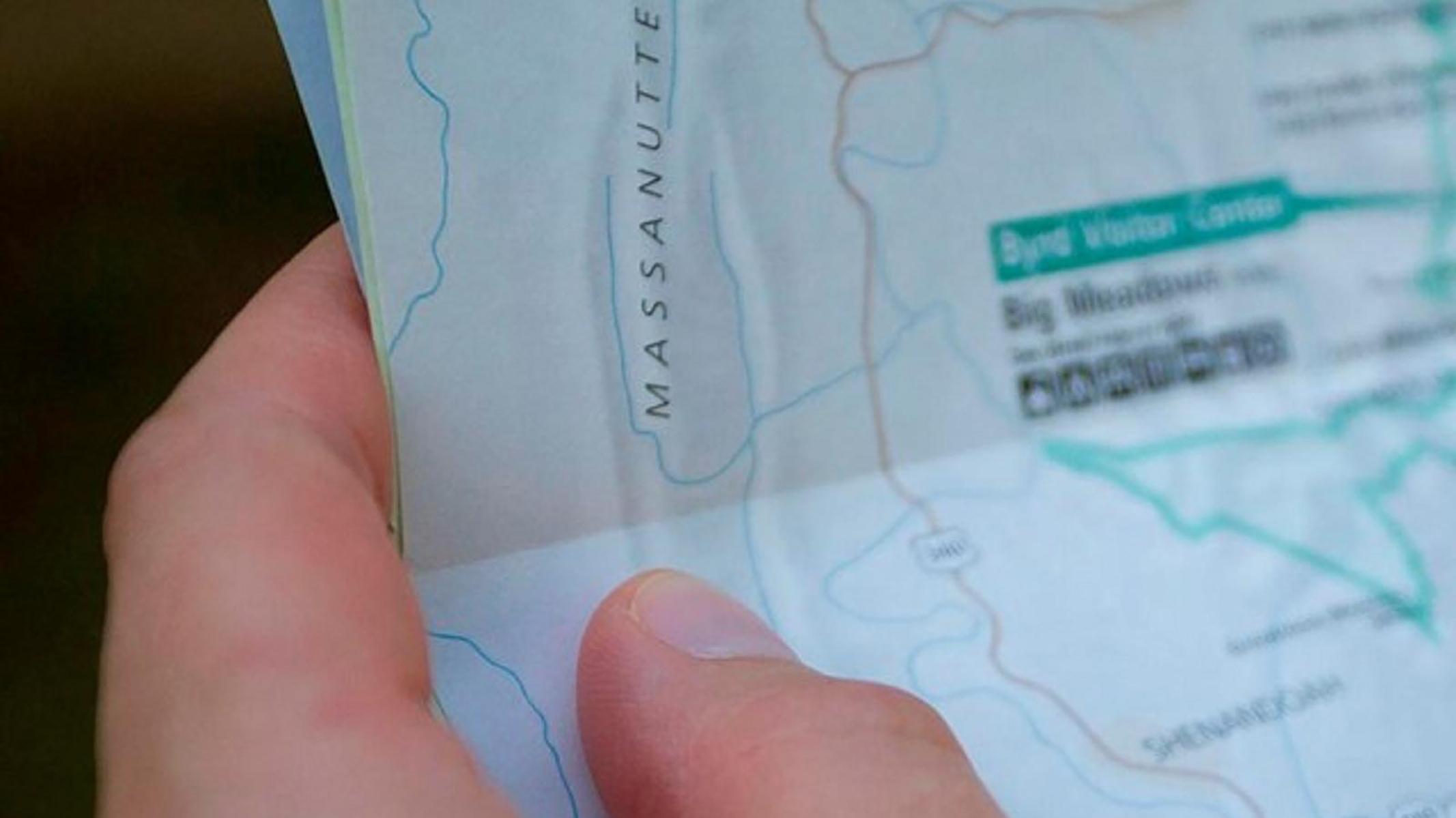 Closeup of a hand holding a park map. 