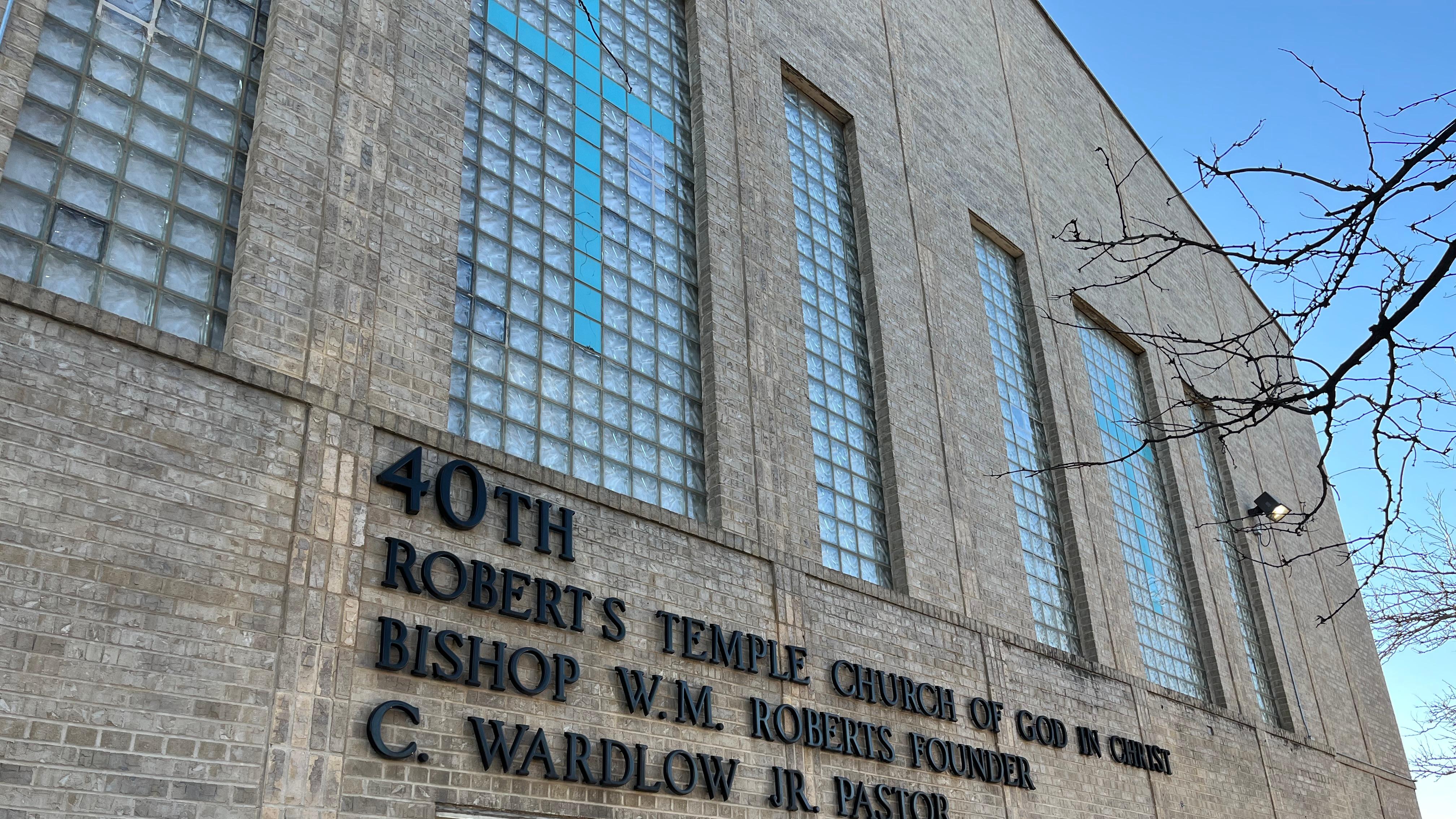 Exterior of a stone building with large glass windows