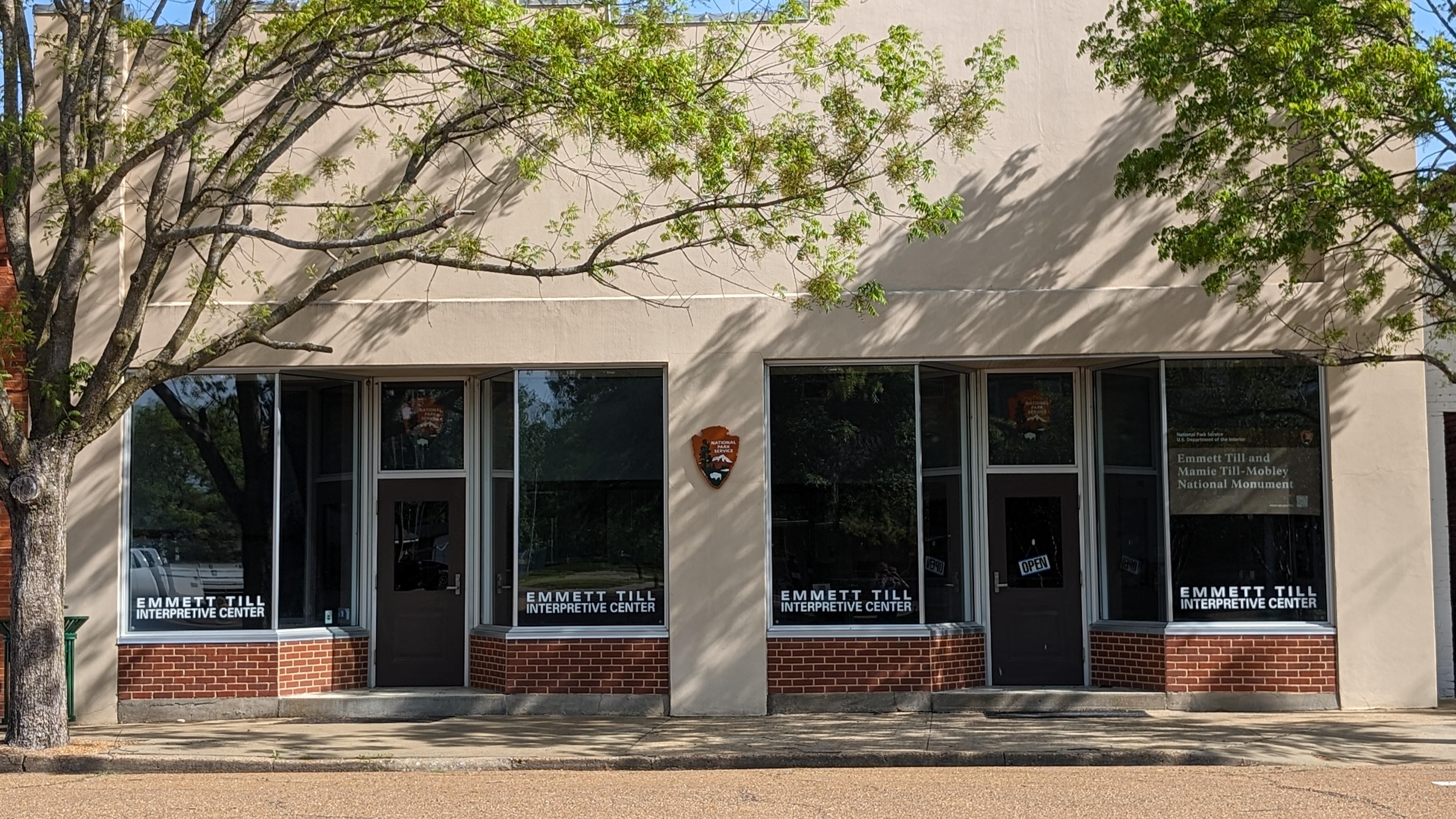 Exterior of a storefront with an open sign in the window
