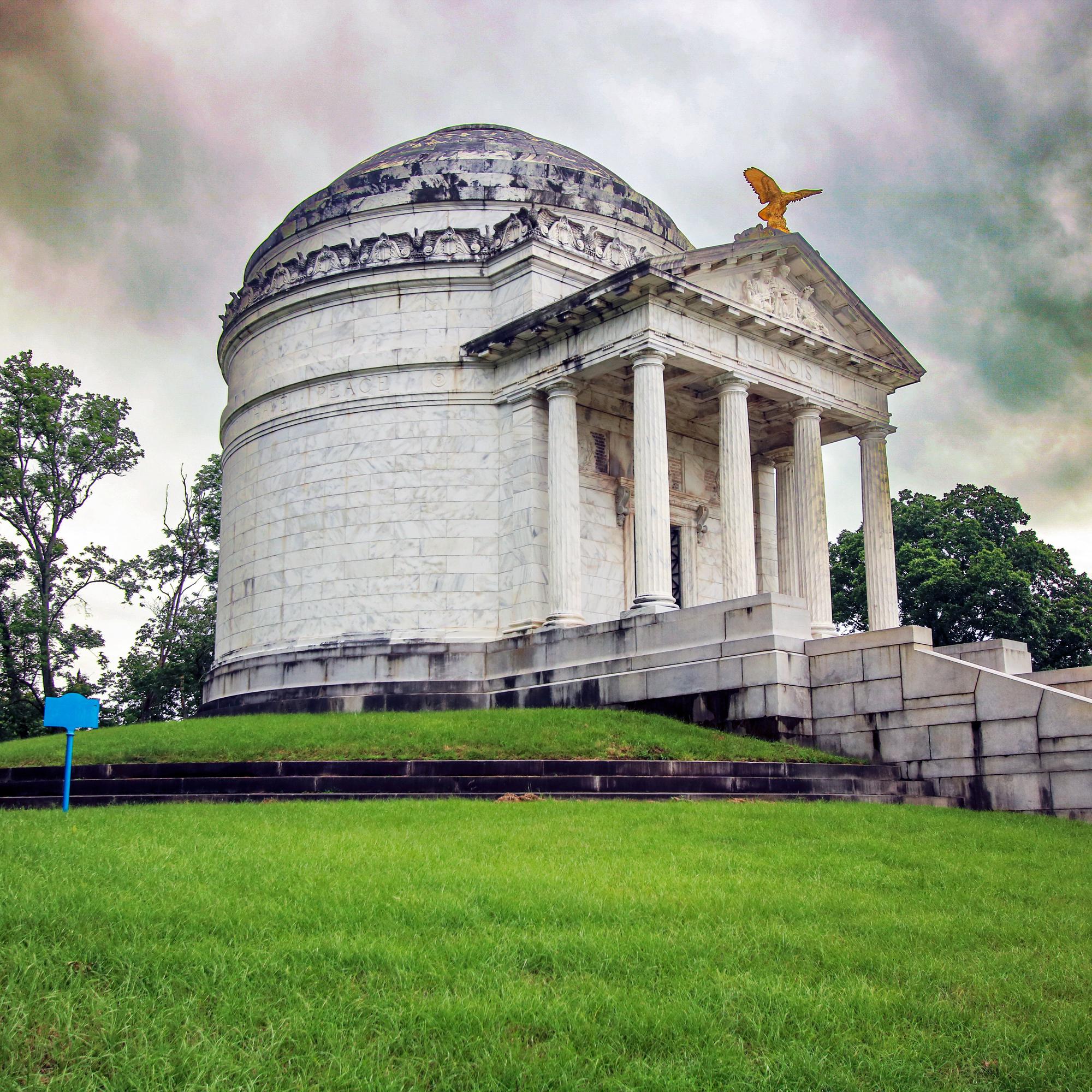 Large white marble building. Round with domed roof. On the front is pediment with triangle shaped ro