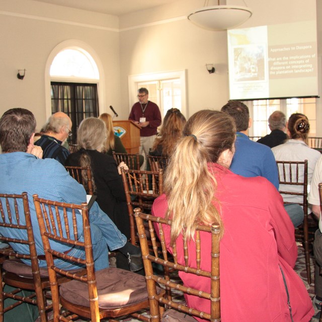 people sitting watching a presentation 