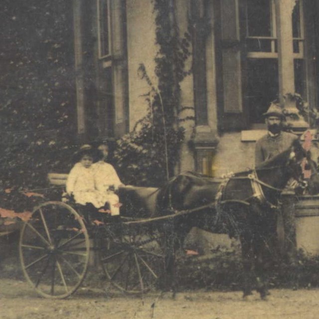 historic photo of a carriage in front of a building 