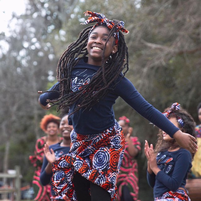 dancer in costume smiles