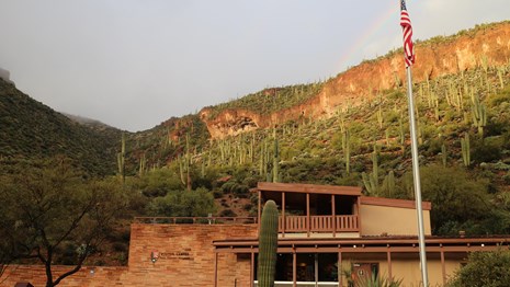 Visitor center with a cliff dwelling above