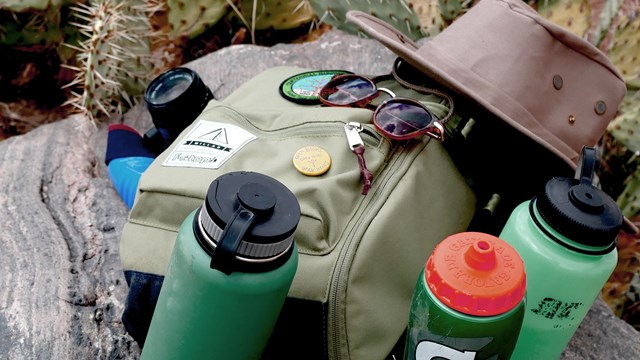 Hiking gear is staked on a rock.