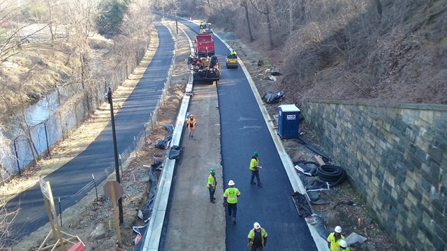 workers work on road, viewed from above