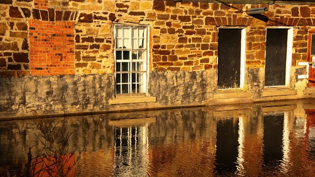 mill race running past a brick building