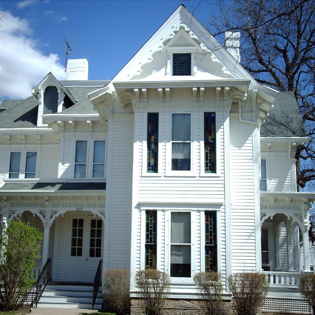 Photo of white two story house. 