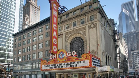Ornate theatre with large sign. 