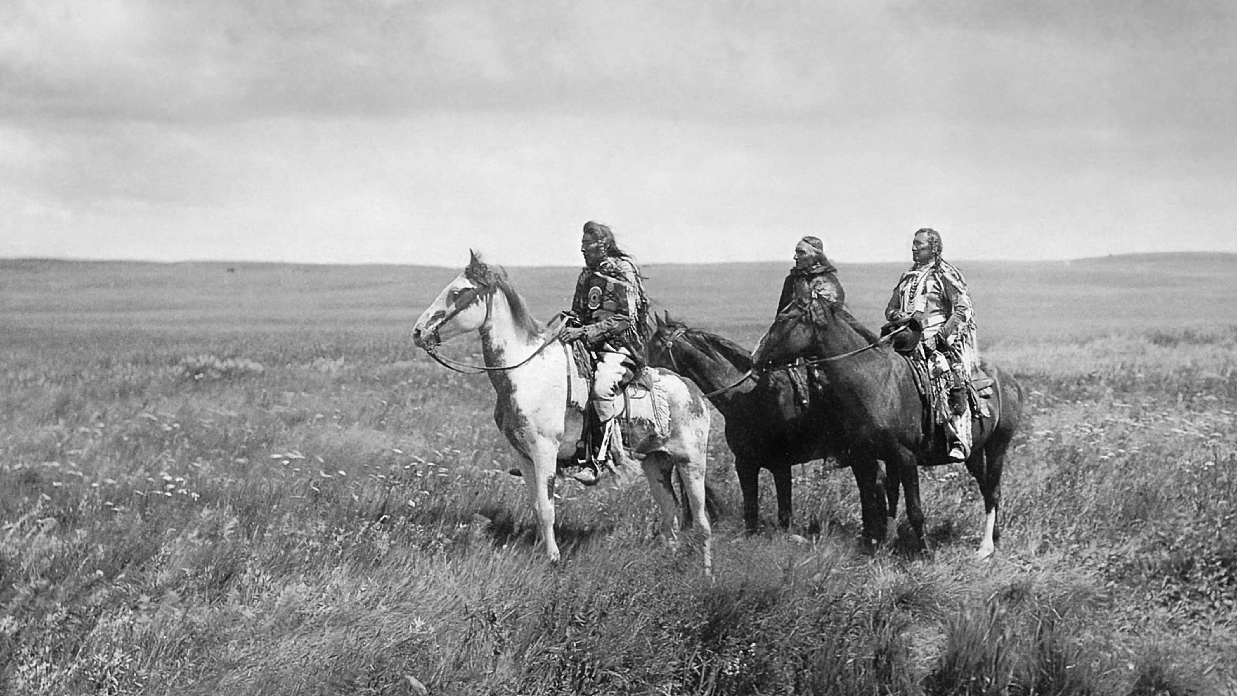 three piegan chiefs on horseback