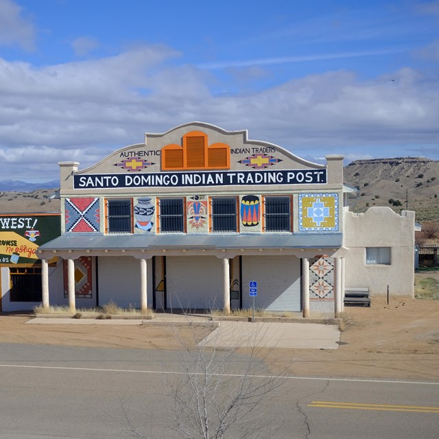 Two historic store fronts in a desert setting.
