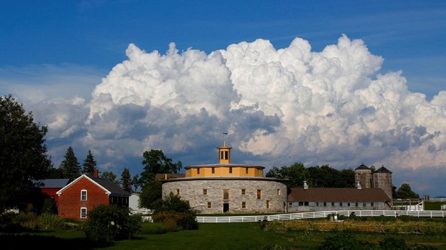 round stone barn in a rural setting