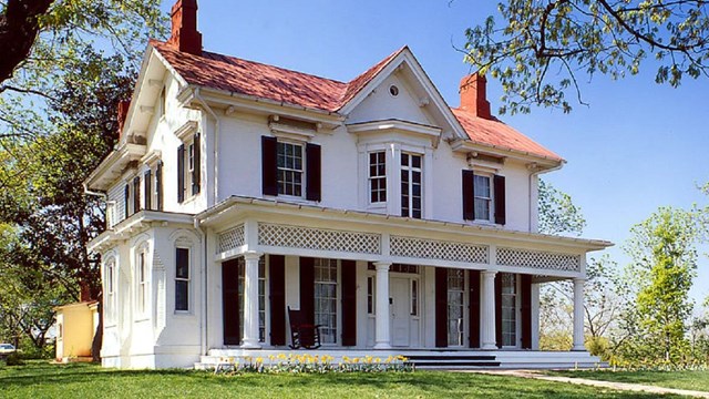 Two-story house on a hill. NPS photo.