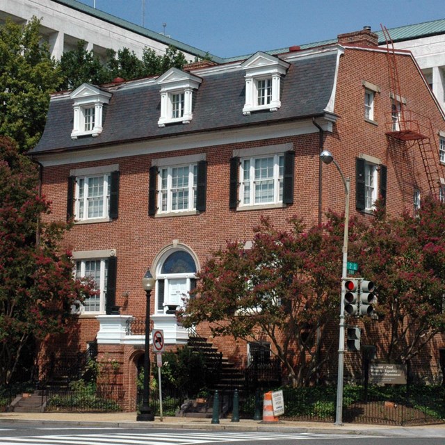 Three-story brick house with gabled roof. NPS photo. 