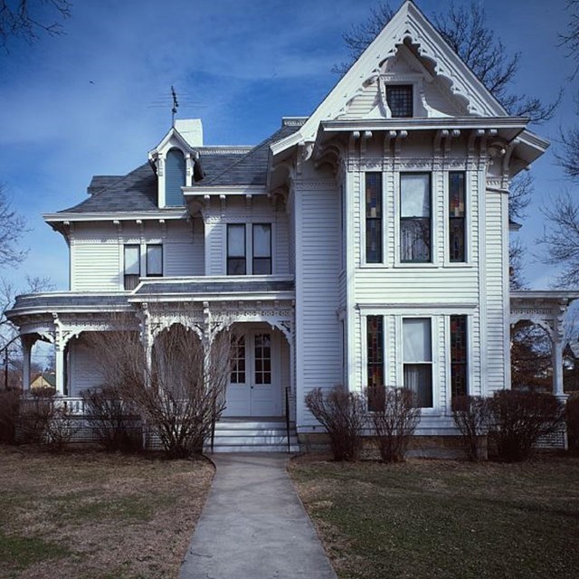 Color photo graph of Truman house with two-and-a-half stories and wrap-around porch. Library of Cong