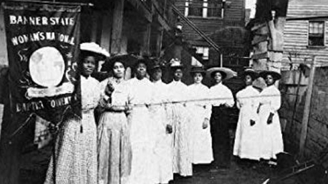 Group of women holding a suffrage banner. Library of Congress. 