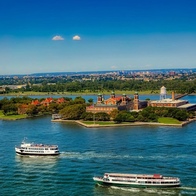 Photo of Ellis Island and boats from above. CC0