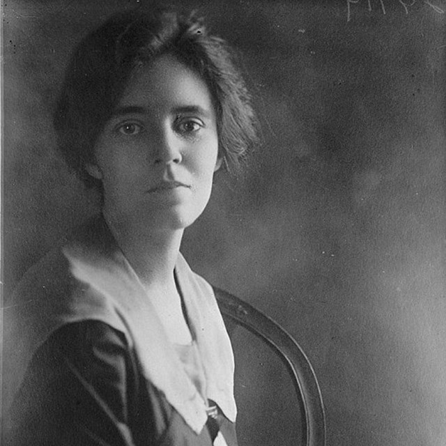 Photo of a woman sitting. 