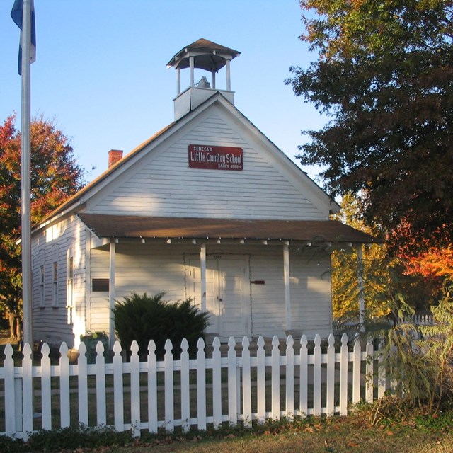 Photo of a one room school house with bell tower. Photo by TheWhitePelican  CC BY-SA 3.0
