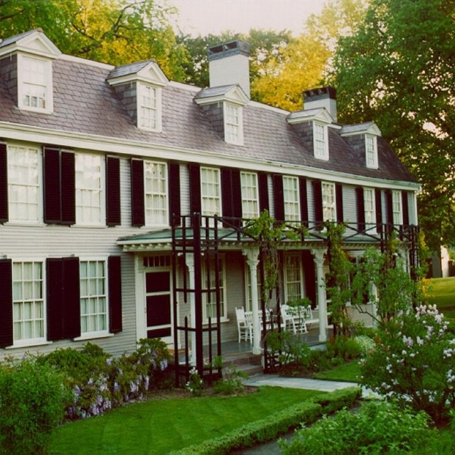 Photo of a two story house with gardens, courtesy NPS. 