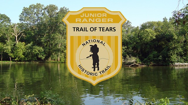 A calm river with dense bank vegetation with a junior ranger badge overlay.