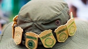A Junior Ranger showcases his badges from across the country.