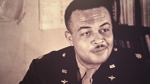 Photograph of Tuskegee Airmen George S. Roberts at his desk