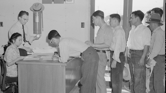 Tule Lake Relocation Center, Newell, California. May Miyamoto, evacuee clerk and Hyrum L. Clark, pro