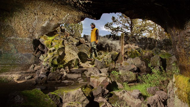 Ranger standing at the cave entrance. NPS Photo Kenneth Ingham