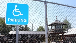 Handicap parking sign on a fence