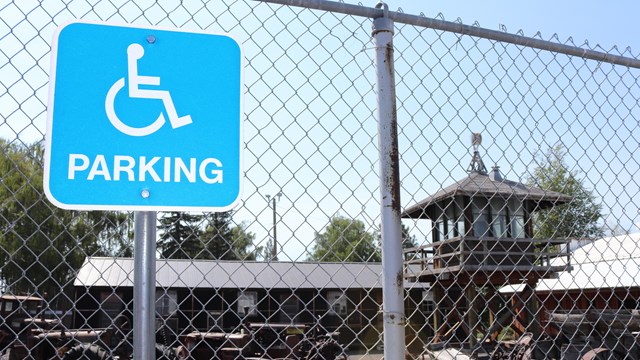 Handicap parking sign on a fence